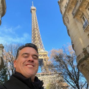 Image of Juan Roque in front of Eiffel Tower for Who is Juan Roque? blog post