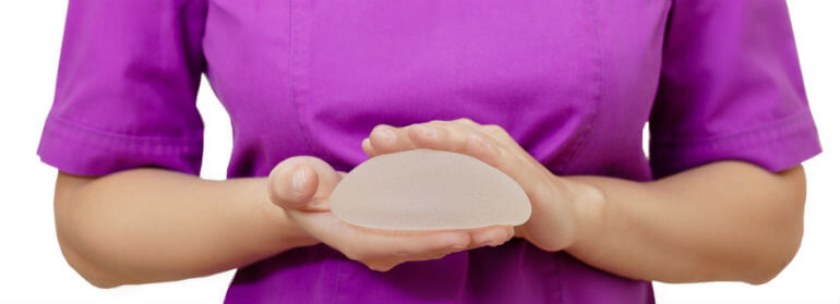 Medical professional holding textured implant