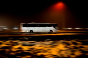 tour bus traveling on interstate at night