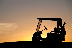 golf cart in silhouette at sunset