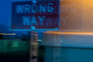 photo of wrong-way sign at night
