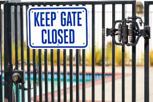 sign on gate outside of swimming pool