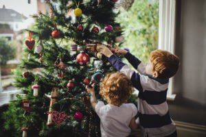 kids pulling at tree ornaments
