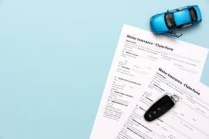 blue background with insurance forms under key fob