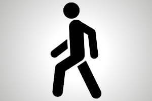 black pedestrian icon on the move