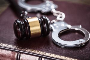 handcuffs and gavel on law book