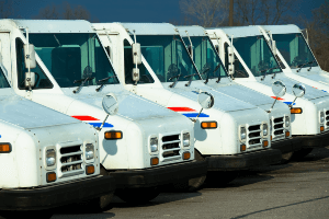 USPS trucks lined up in a parking lot