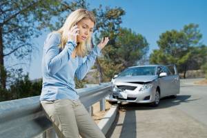 woman looking angry on the phone after car crash